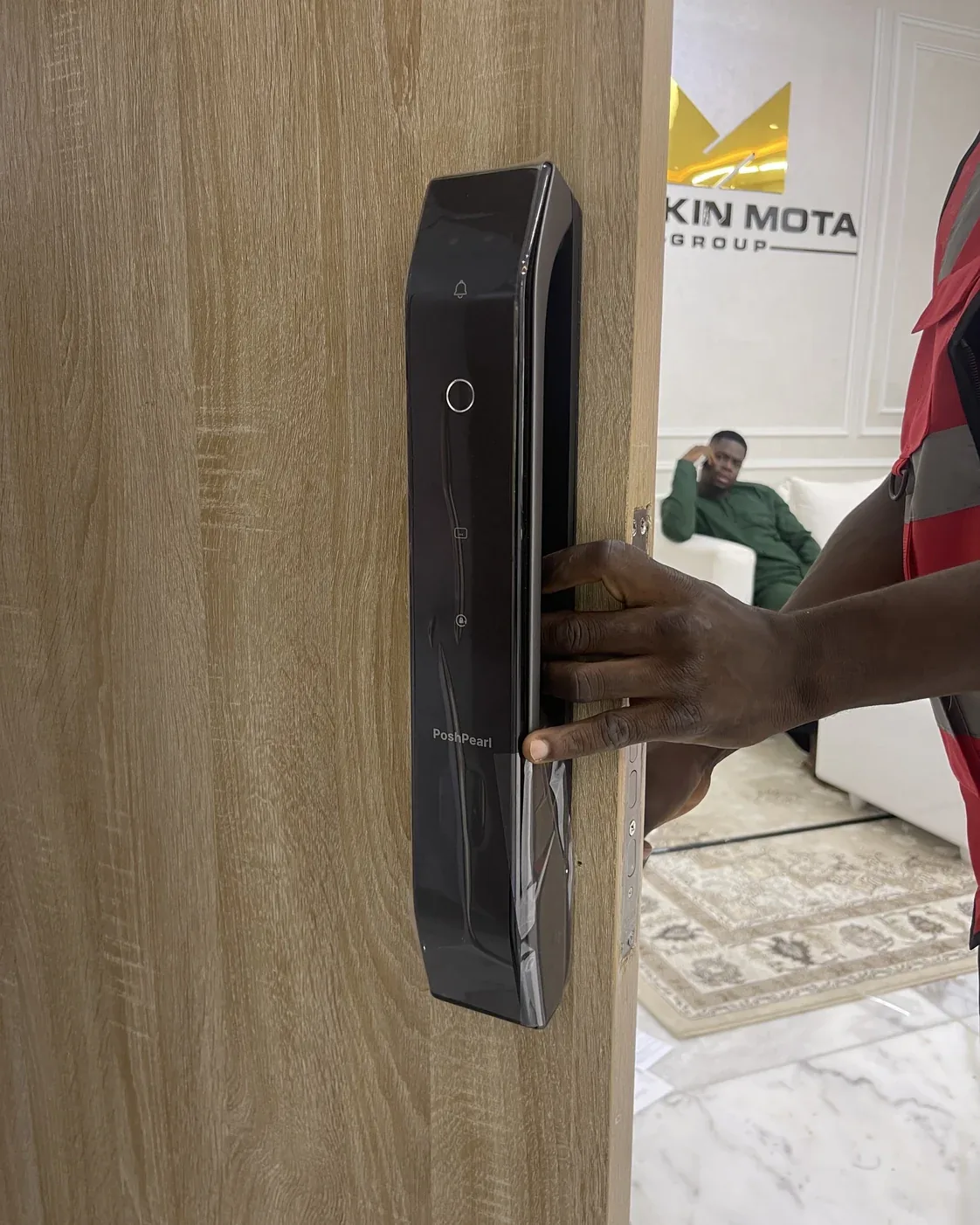 Engineer testing and handing over a newly installed smart lock