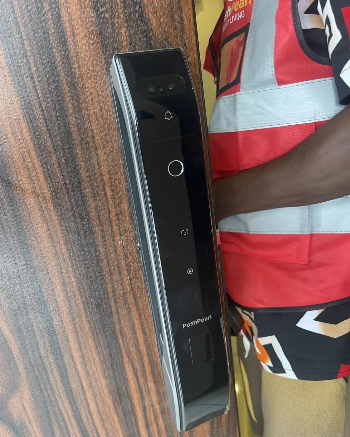 Poshpearl engineer beside an installed smart lock during service delivery